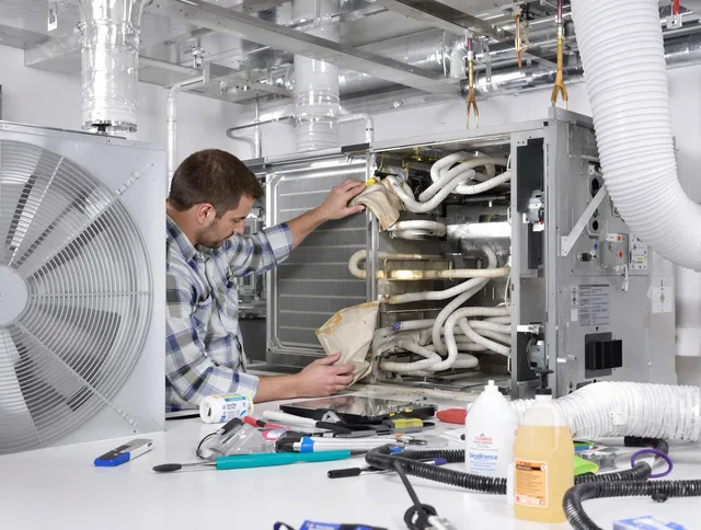 Raynham Air Duct Cleaning specialist performing precision AC coil cleaning in Raynham