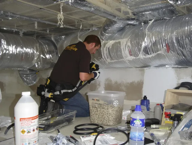 Raynham Air Duct Cleaning specialist performing professional mold removal from air ducts in Raynham