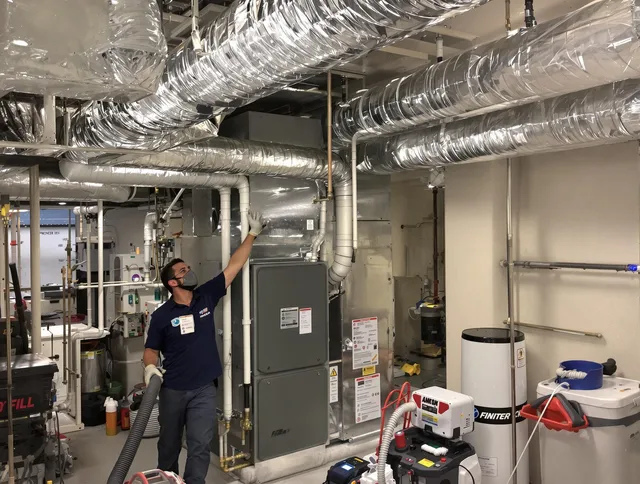 Raynham Air Duct Cleaning specialist performing thorough furnace duct cleaning in a Raynham residence