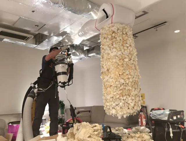 Raynham Air Duct Cleaning technician performing precision vacuum insulation removal in a residential property in Raynham